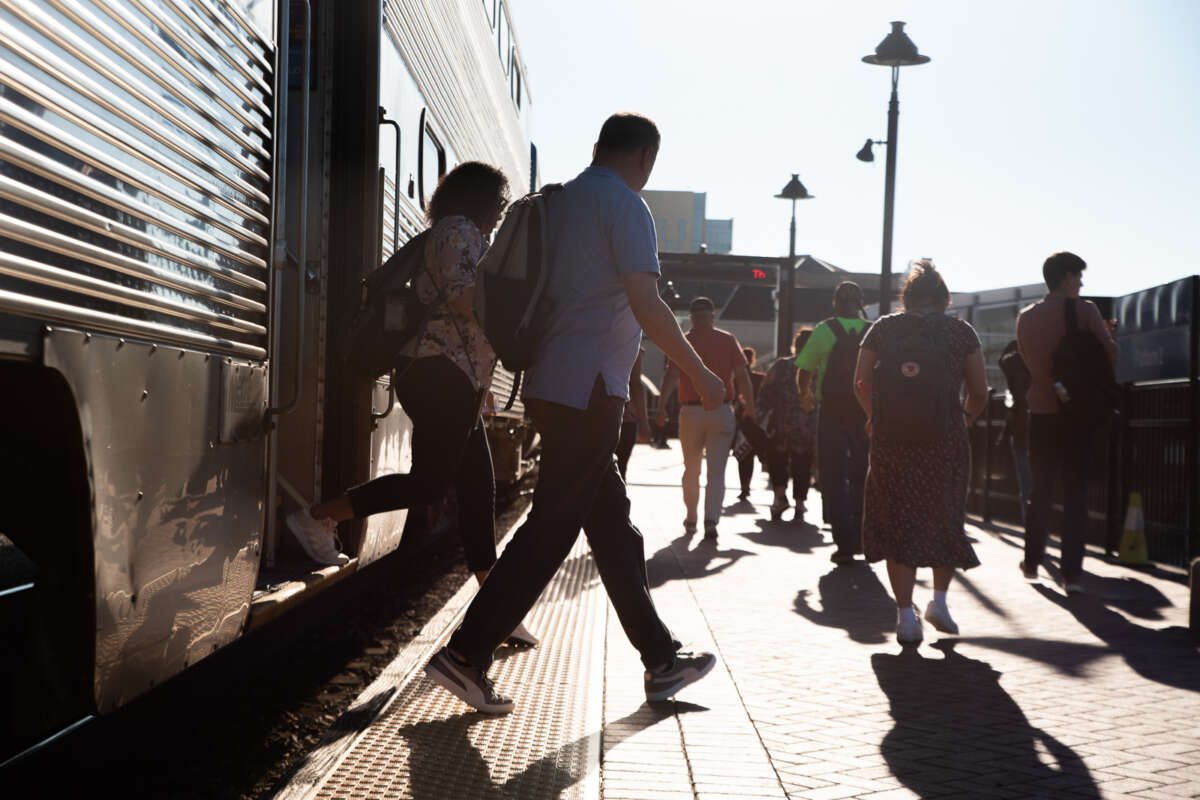 Numerous commuters exiting a Metra train.