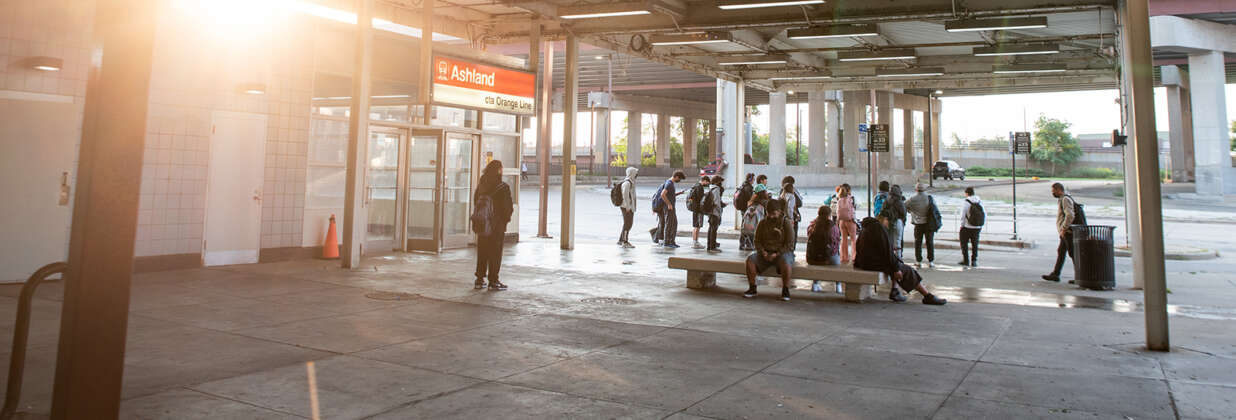 Many people outside of Ashland Red Line train station waiting for transit.