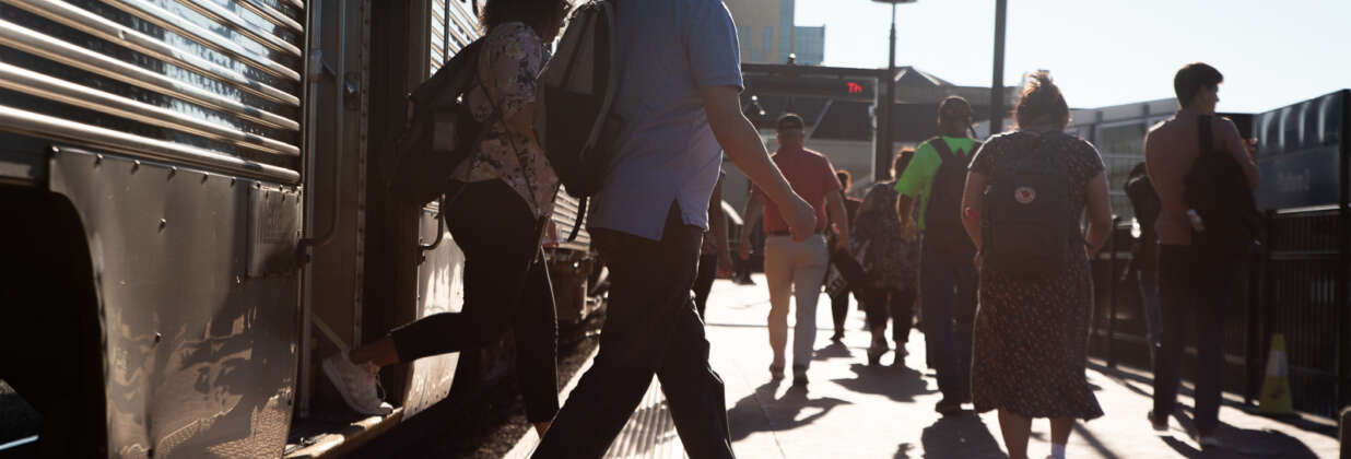 Numerous commuters exiting a Metra train.