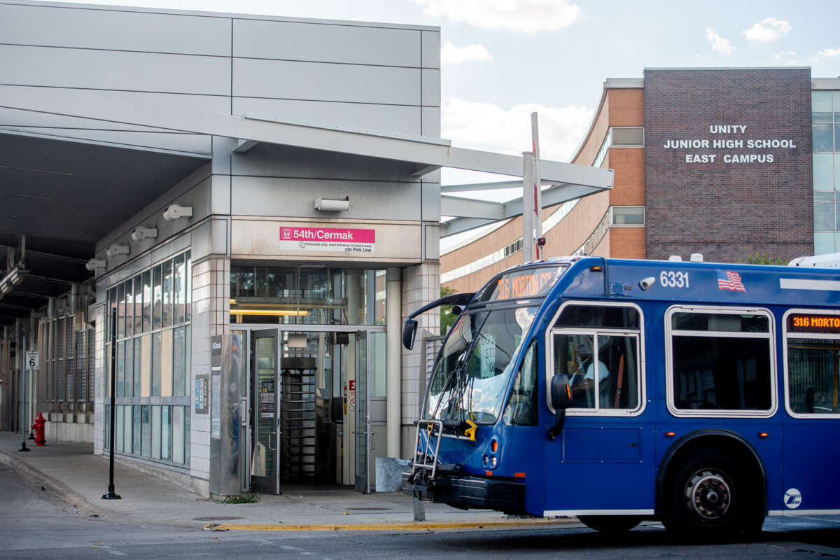 The 54th/Cermak Pink Line station next to Unity Junior High School East Campus with a Pace bus out front.