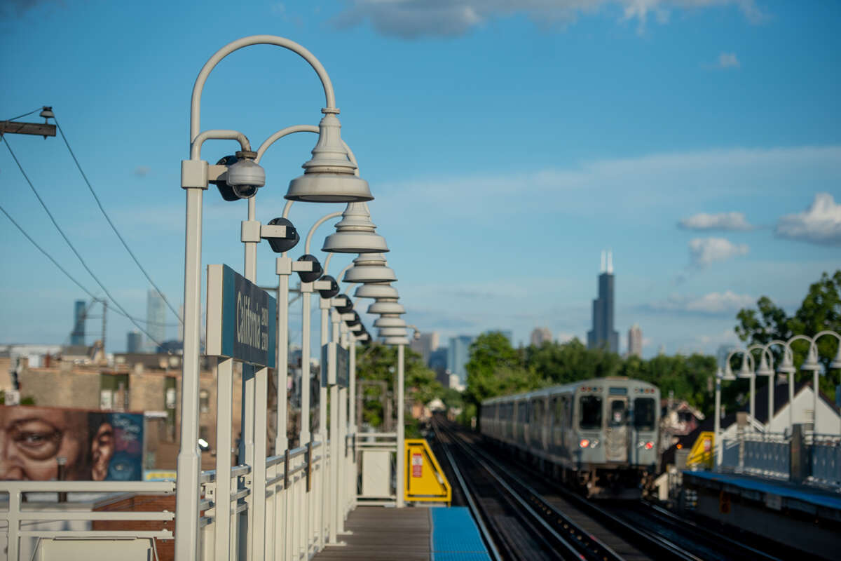 CTA L train on tracks approaching California Blue Line stop.