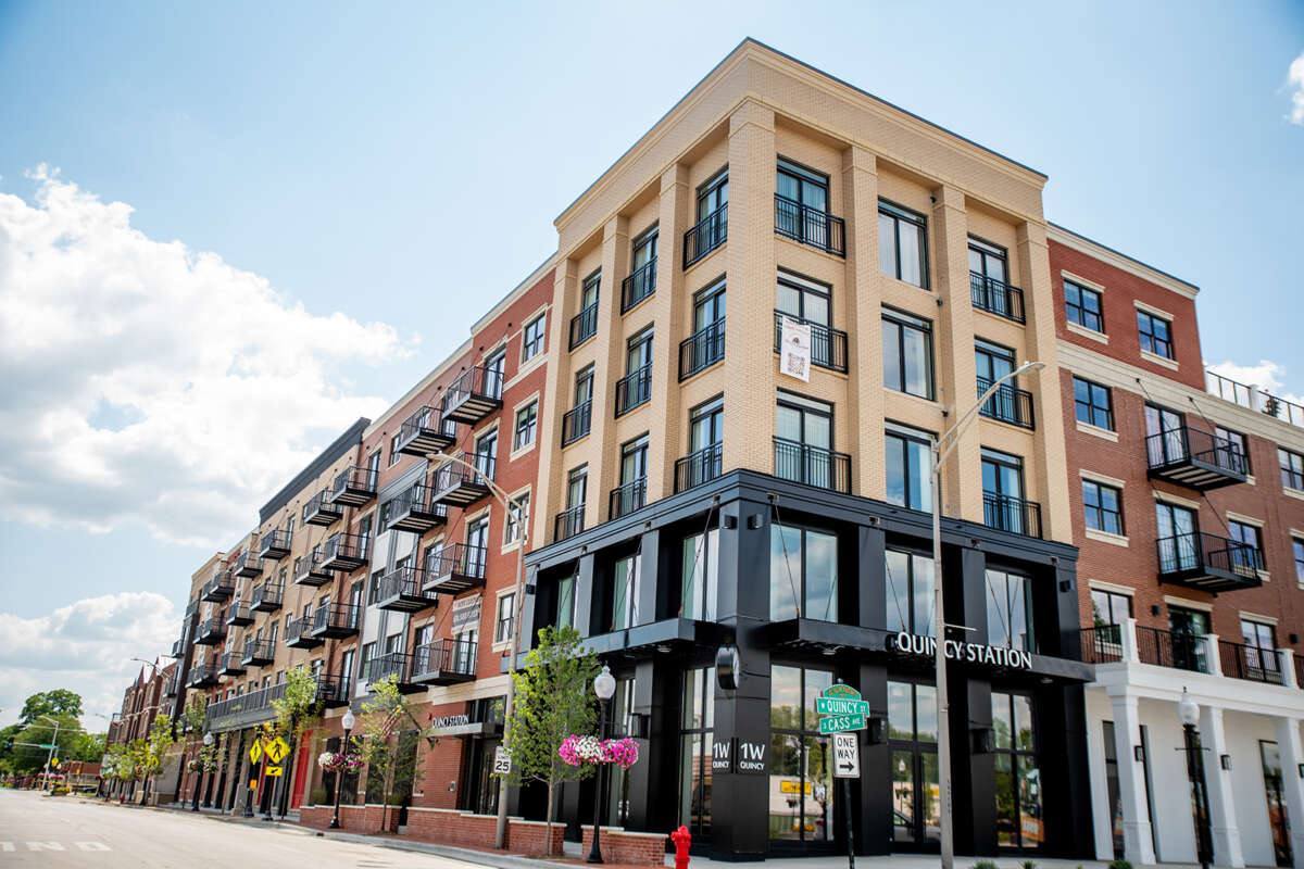 Modern apartment complex on street corner.