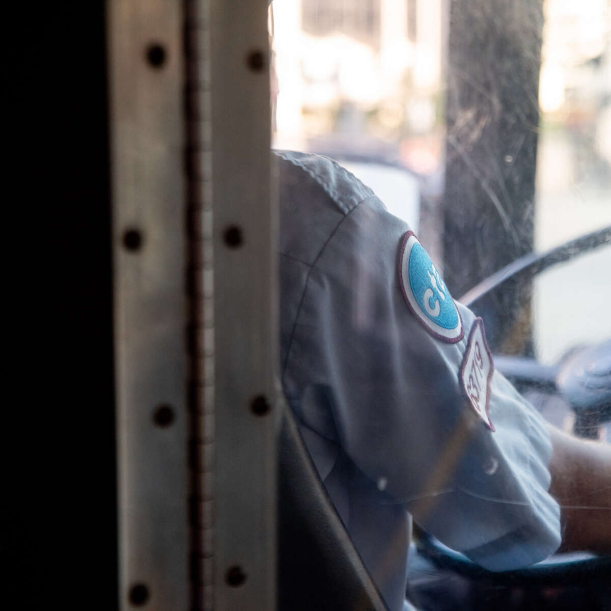 CTA bus driver holding steering wheel.