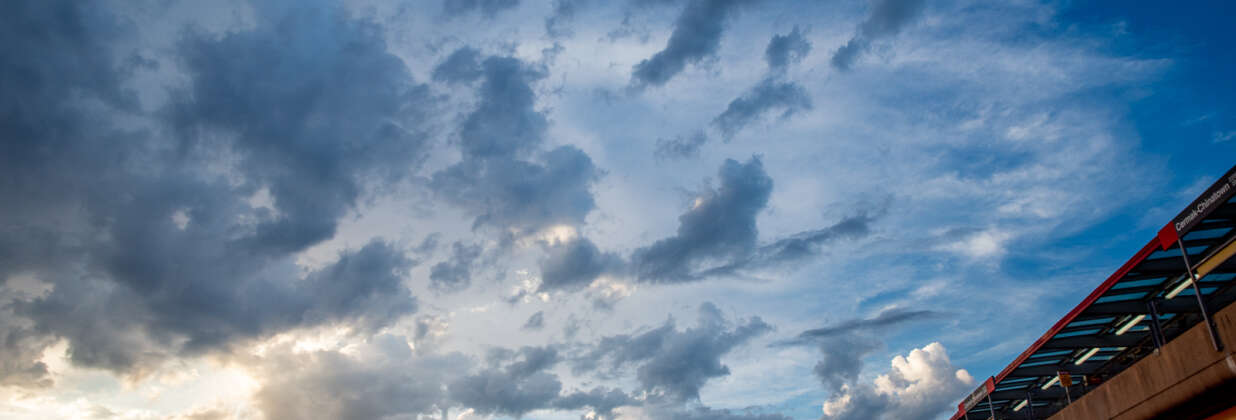 Sunset clouds above train tracks.