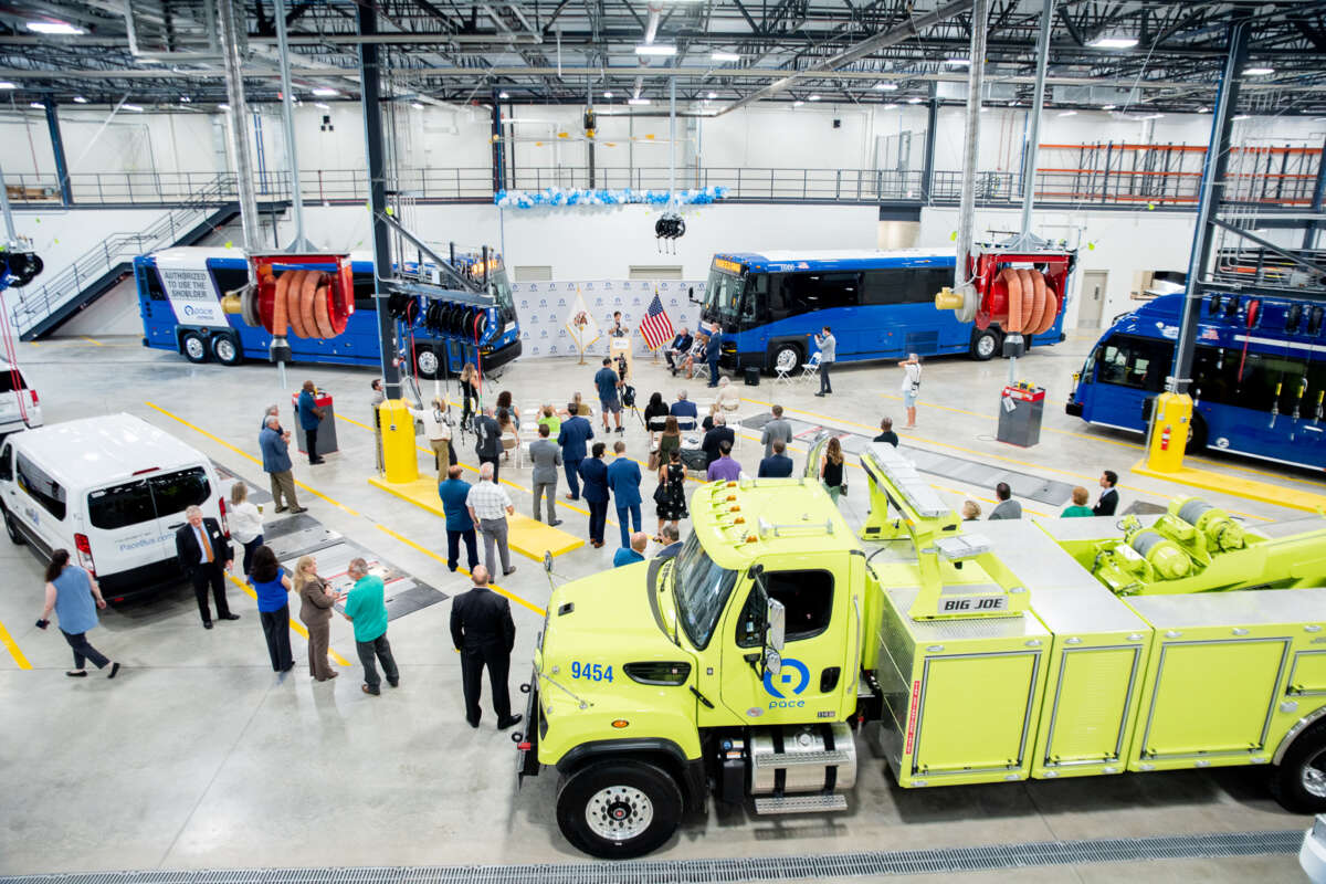 Bird's eye view of Pace busses and trucks inside a warehouse.