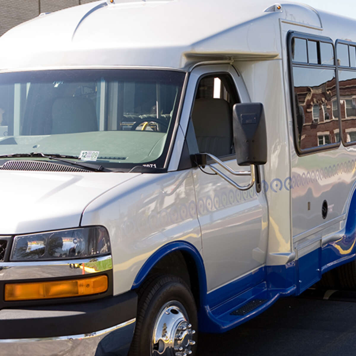 Pace Paratransit vehicles in line with a Pace fixed-route bus.